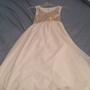 White dress and gold sparkles at the chest